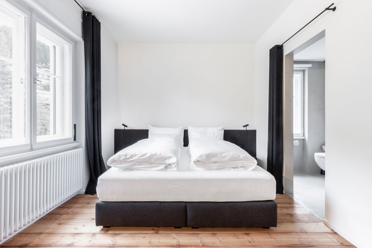 Bedroom with window and dark curtains