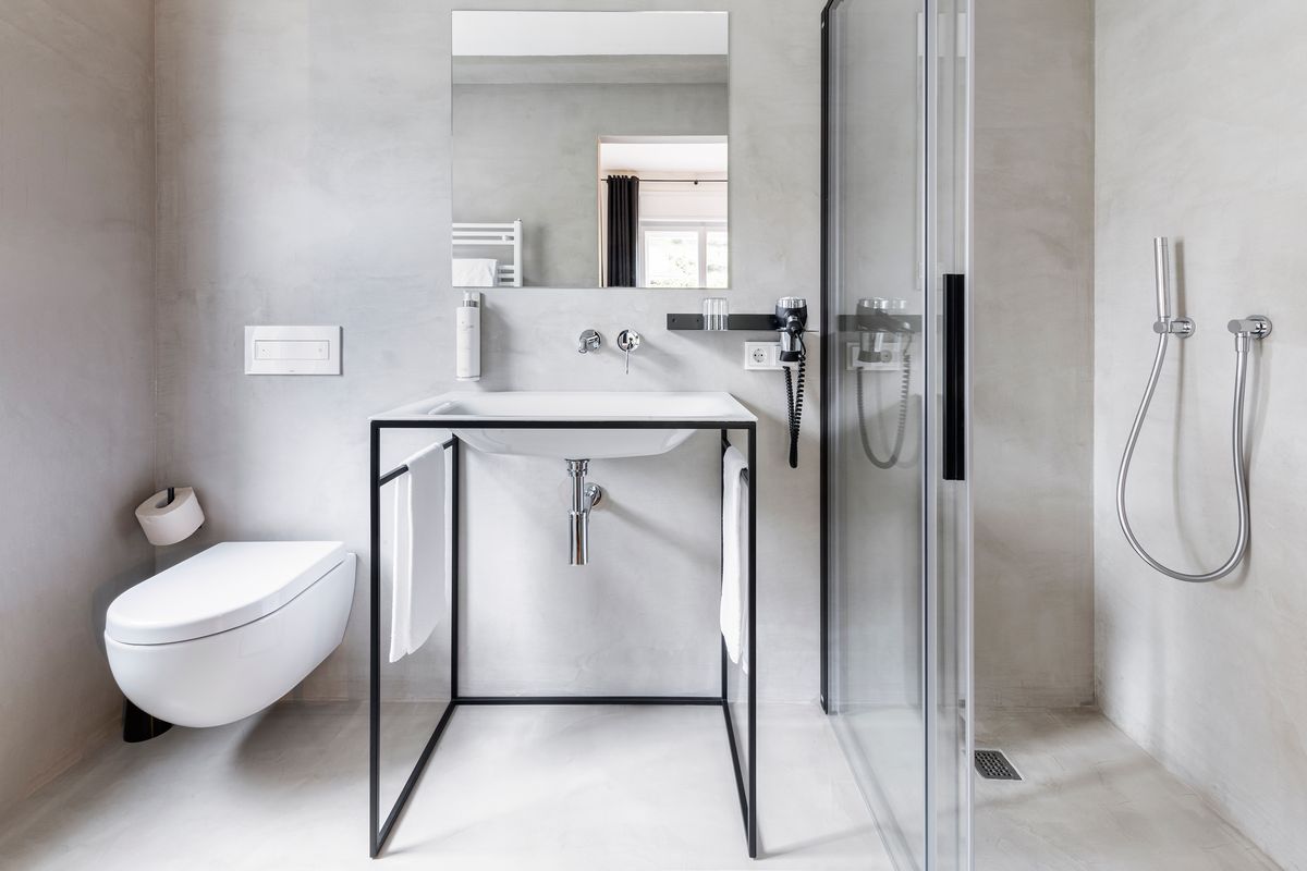 Bathroom with exposed concrete and glass shower