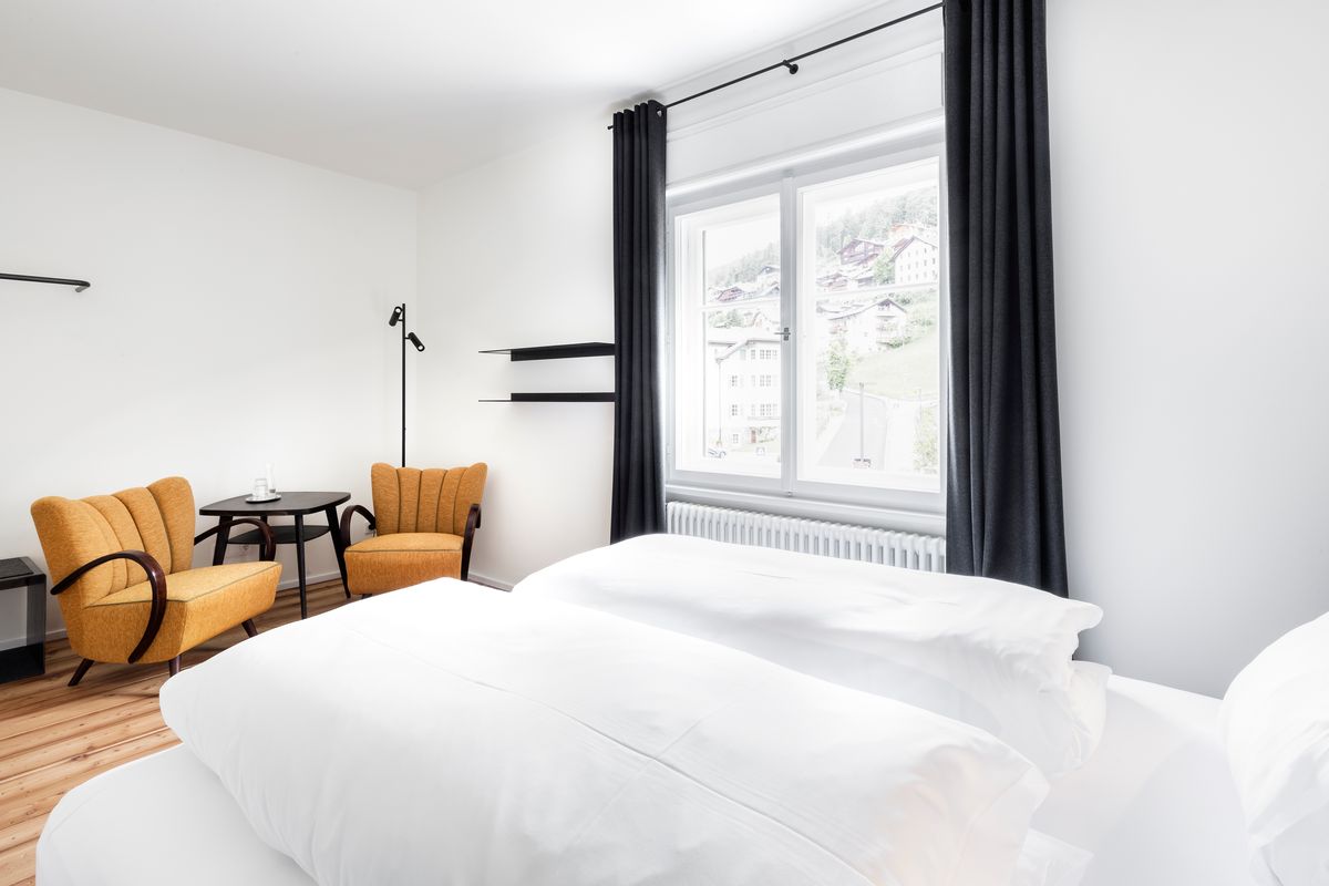 Room with yellow armchairs and double bed