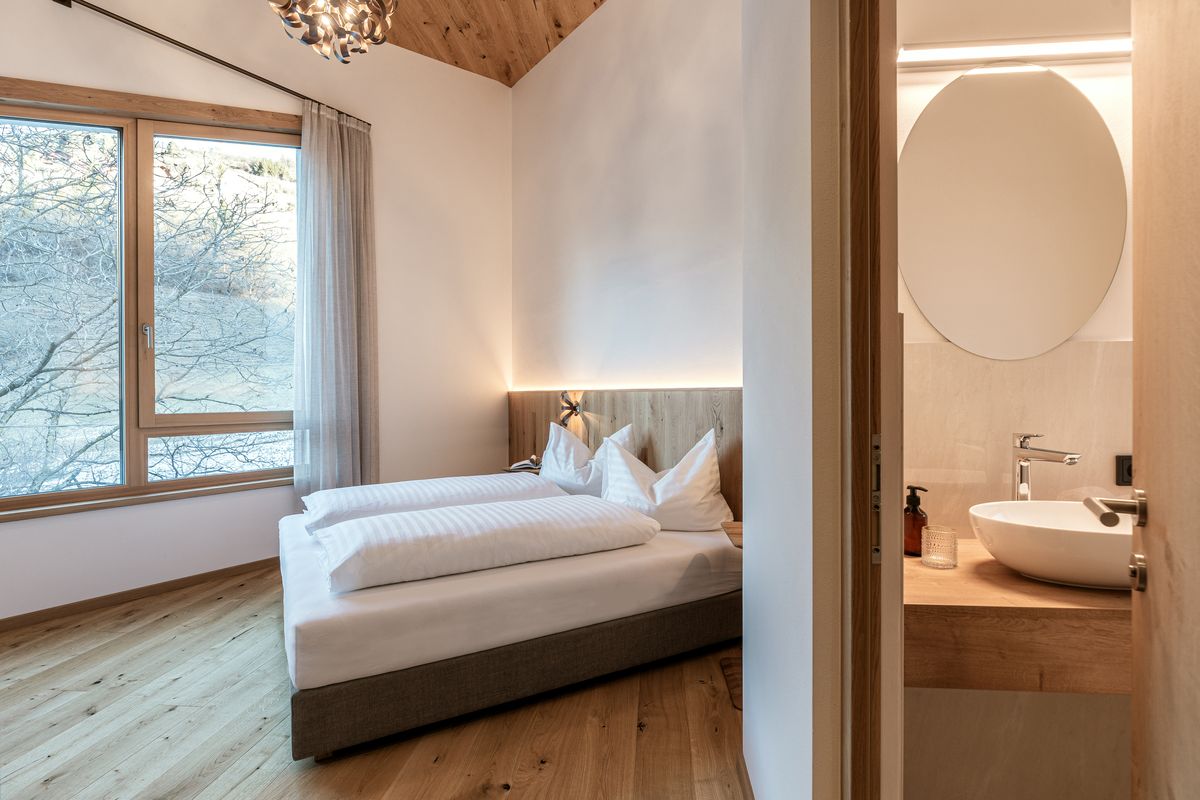 Bedroom with the bathroom in the background