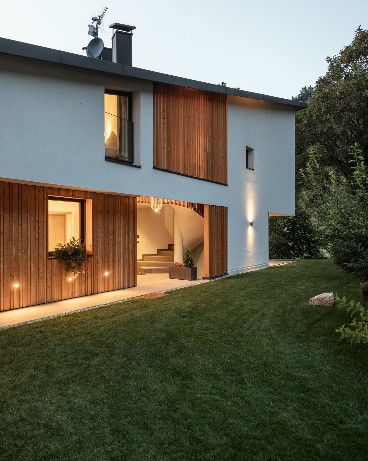 Chalet with timber façade at dusk