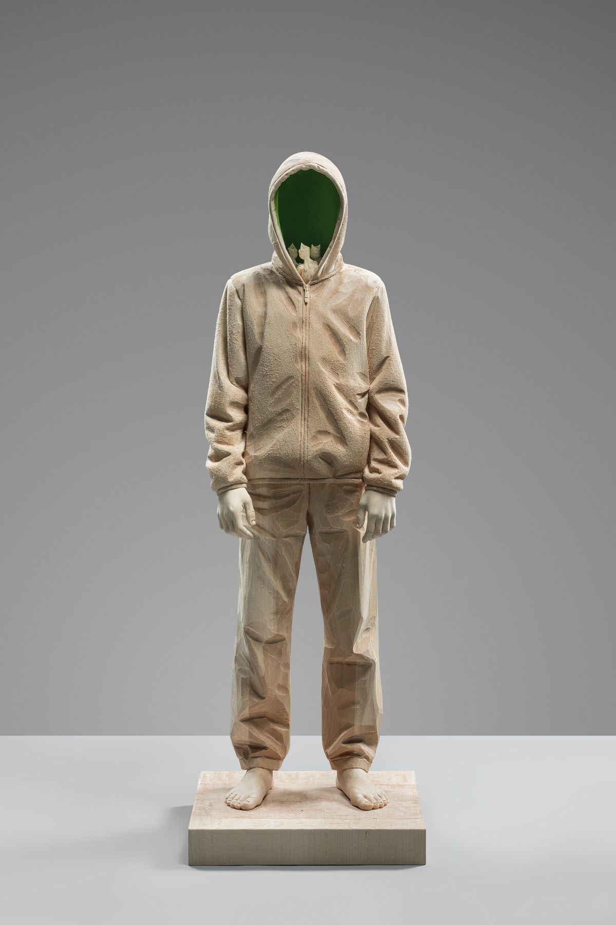 Figure with a green face on a plinth