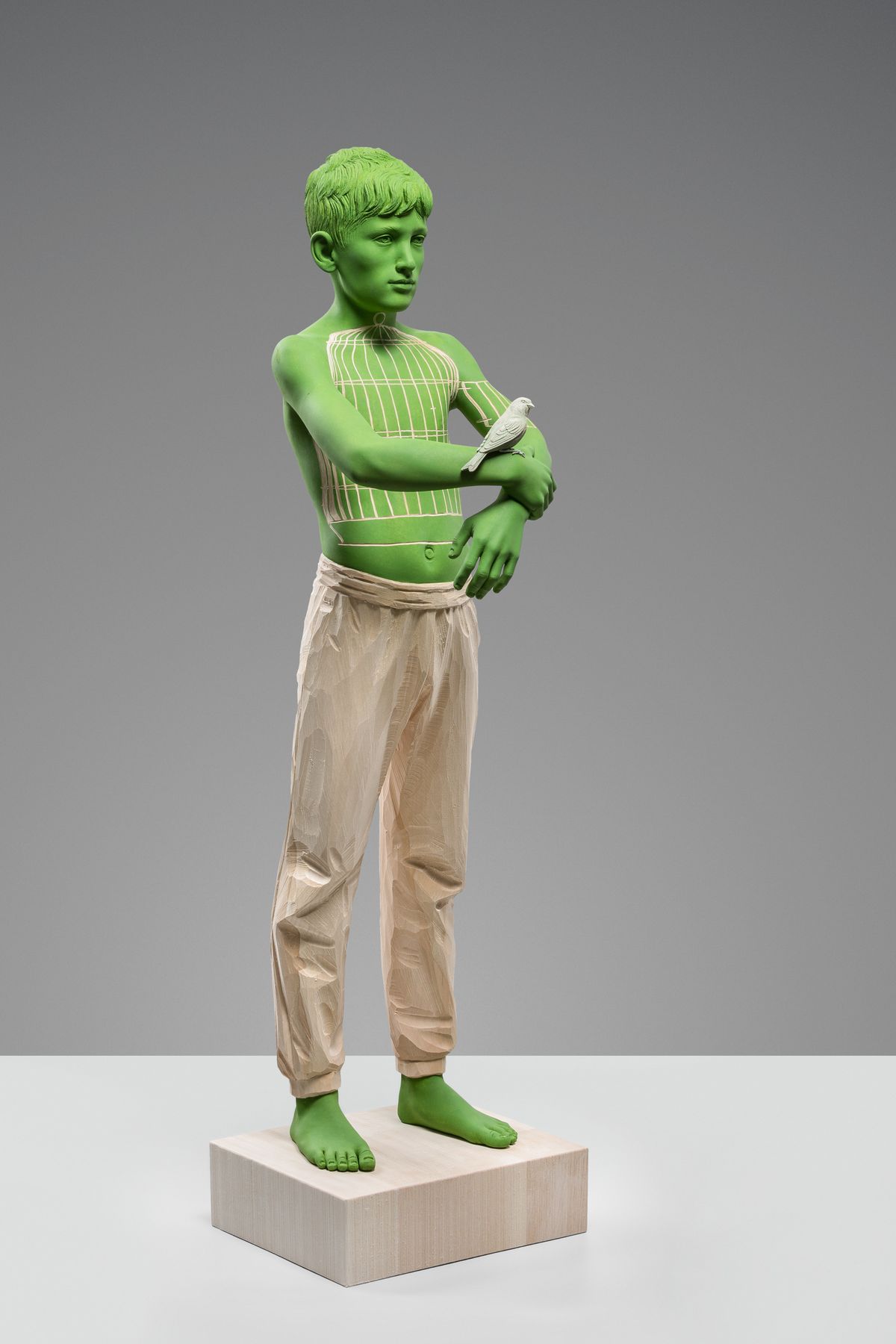 Green figure with arms crossed
