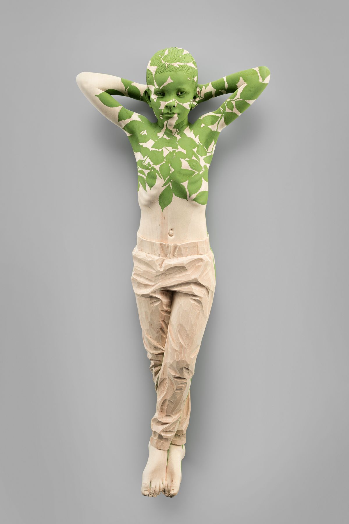 Figure with leaves on the wall