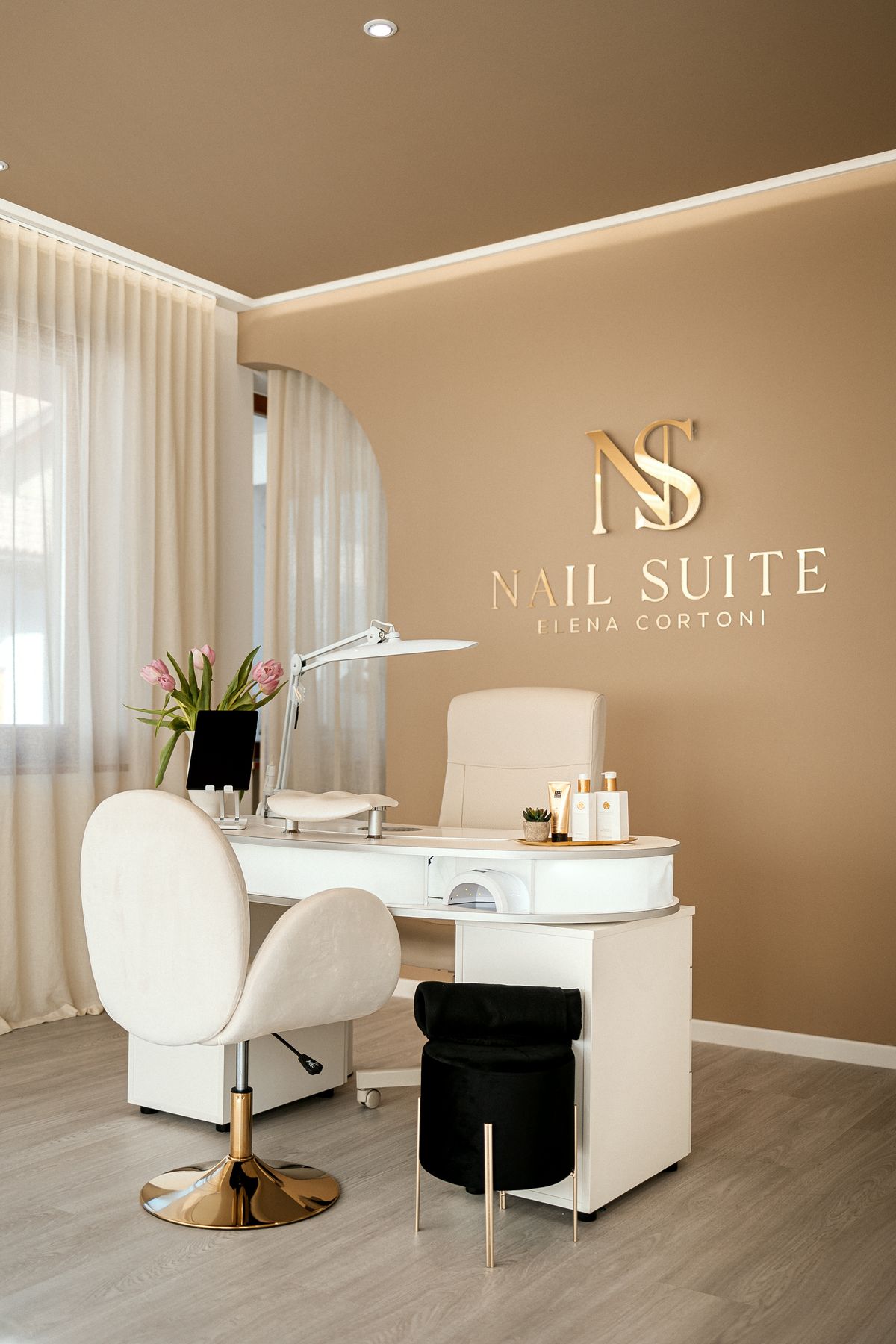 Workstation in front of the logo on the wall