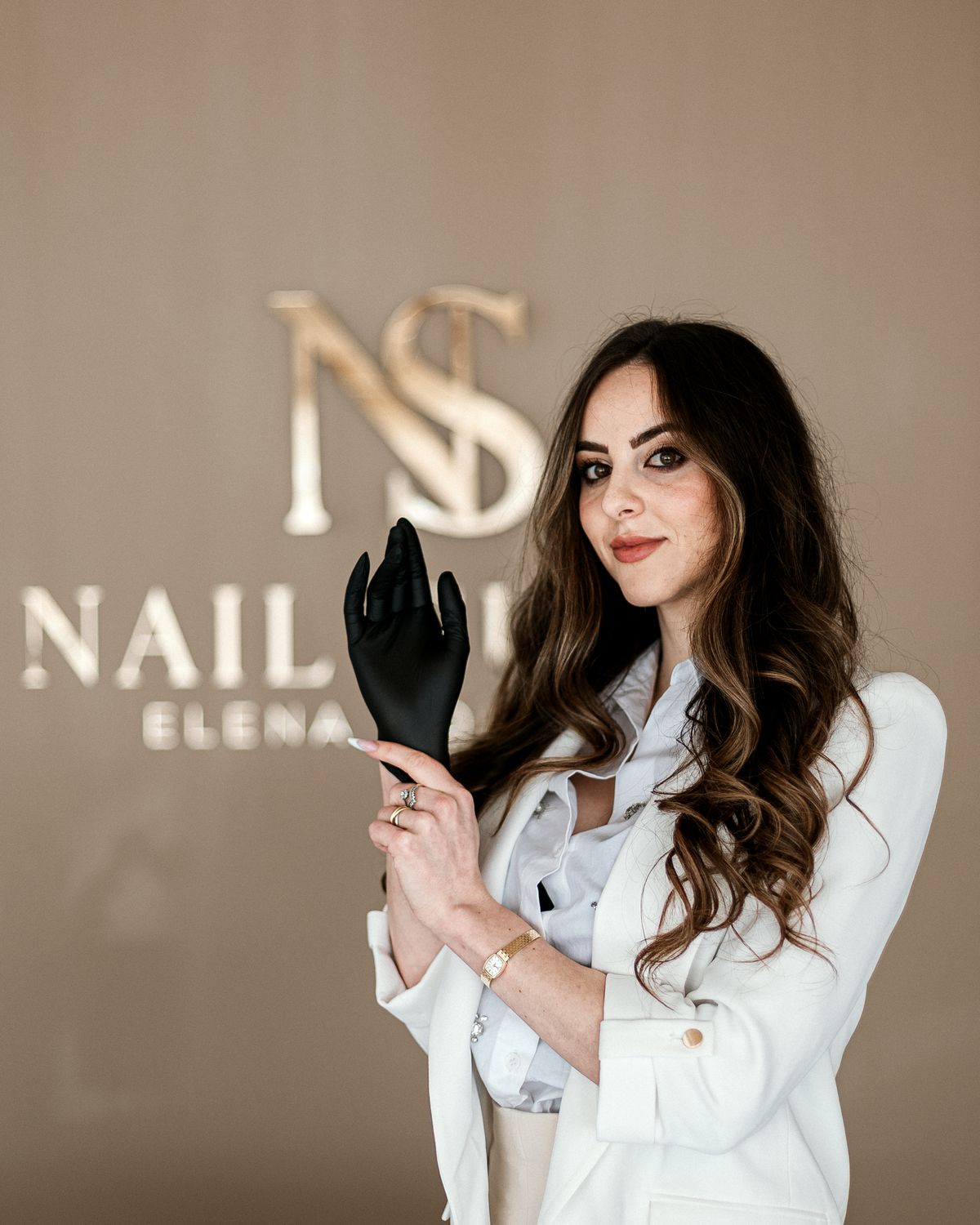 The owner in front of the logo