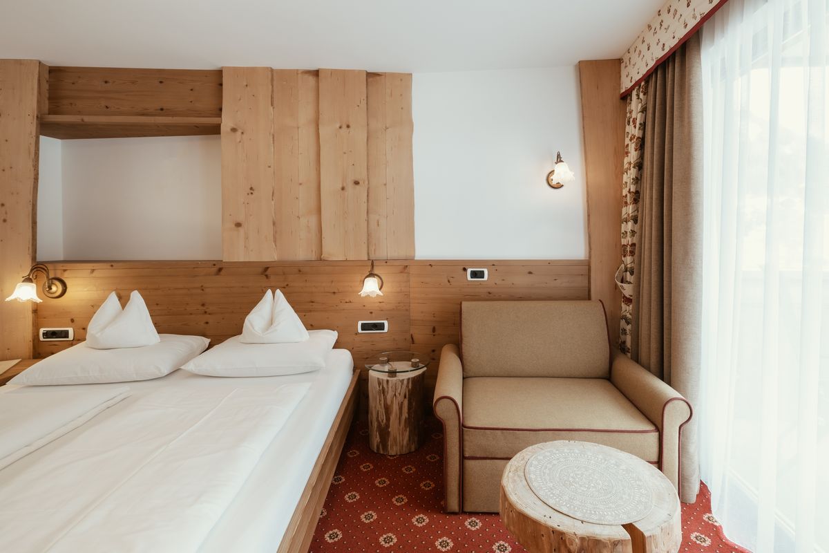 Room with bed and armchair