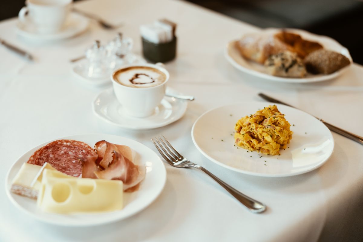 Breakfast with cappuccino and scrambled eggs