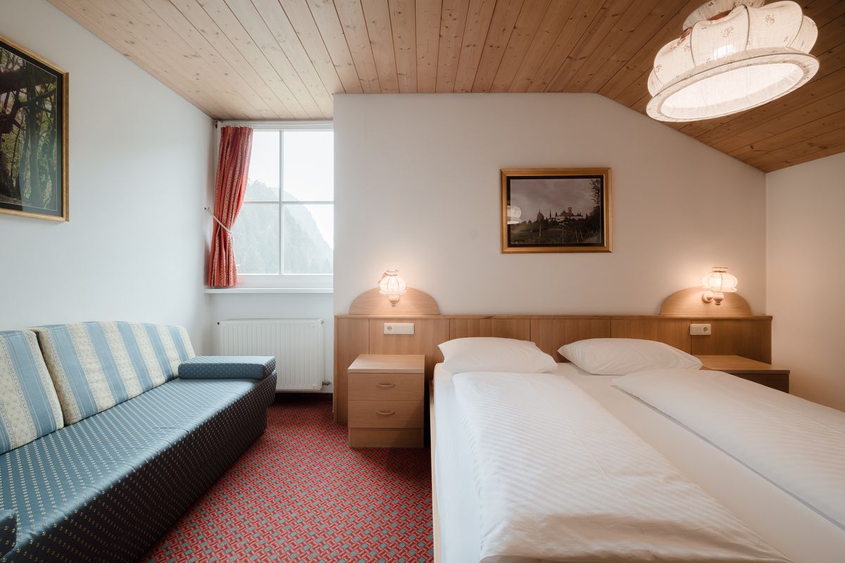 Room with sofa and double bed