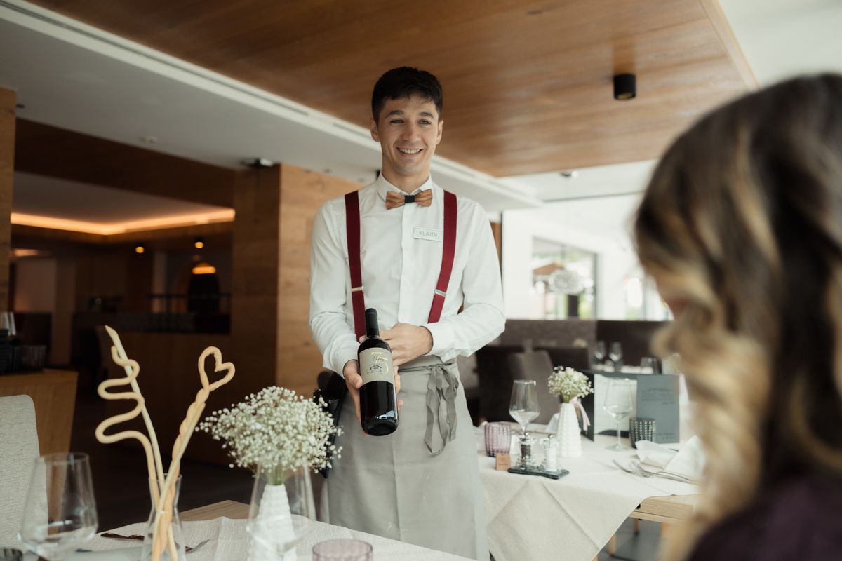 Waiter with a bottle of wine in the restaurant