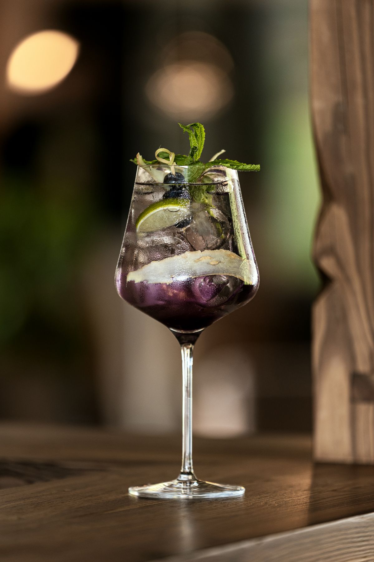 Cocktail in a wine glass with berries