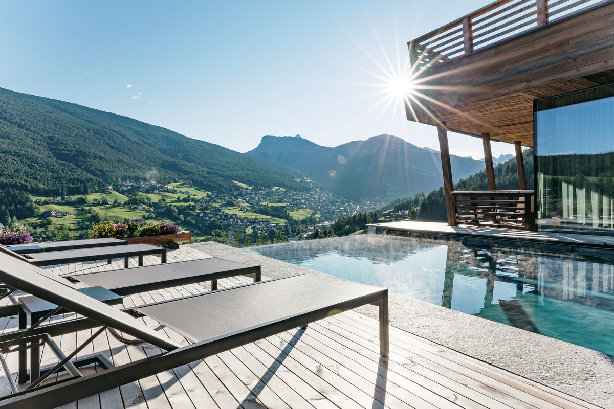 Infinity pool with loungers in the sun
