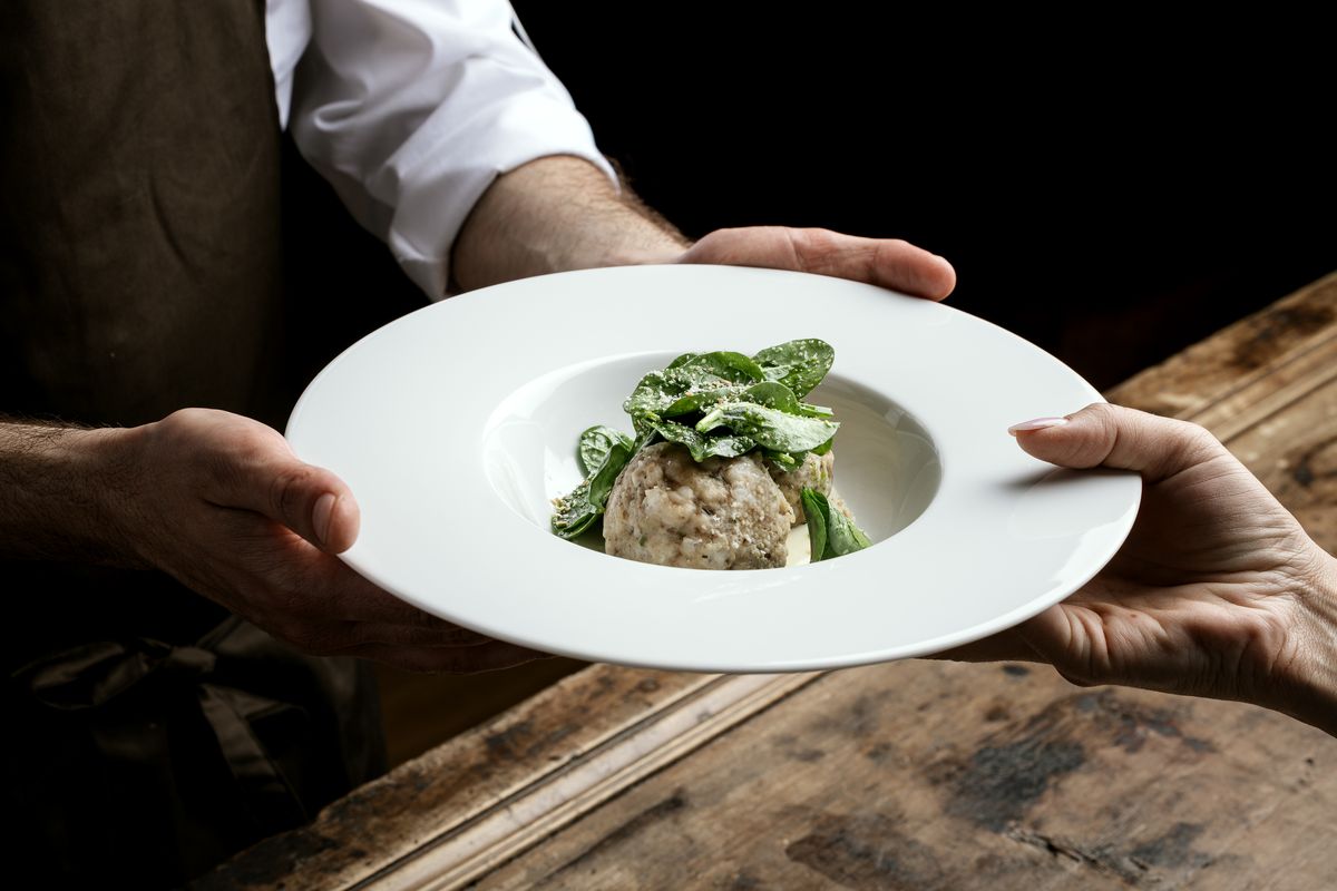 A plate being served over the wooden table