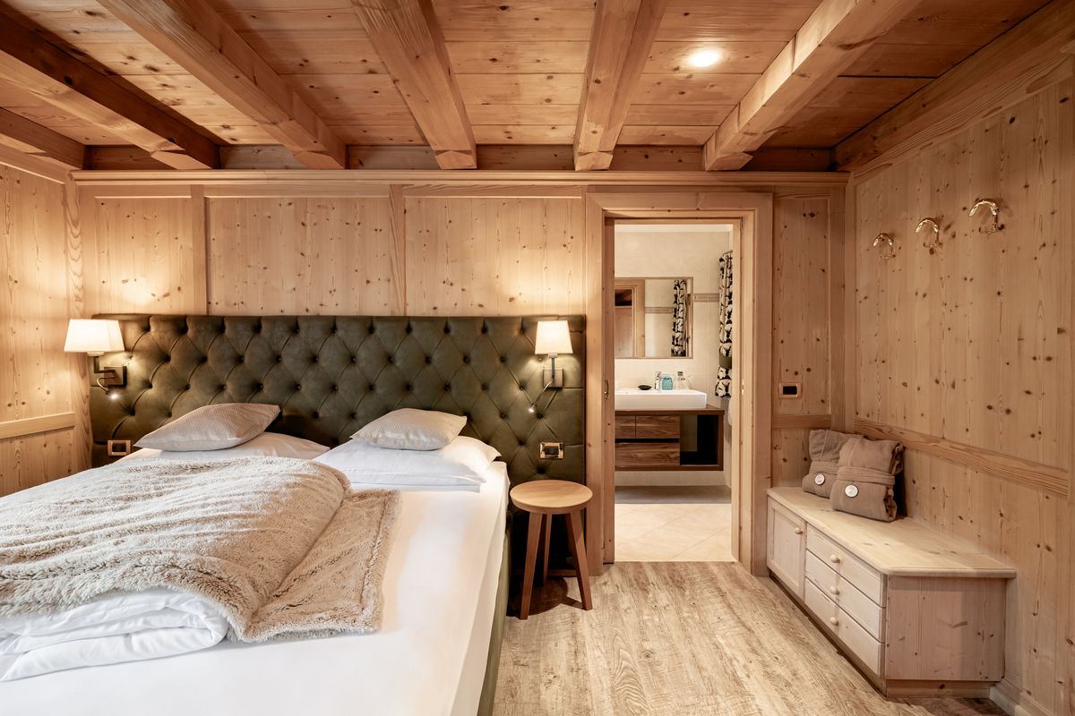 Double bed with green upholstered headboard