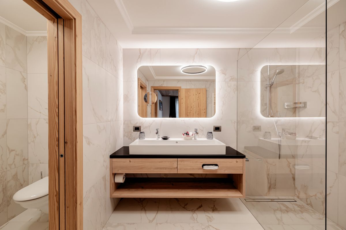 Marble bathroom with illuminated mirror