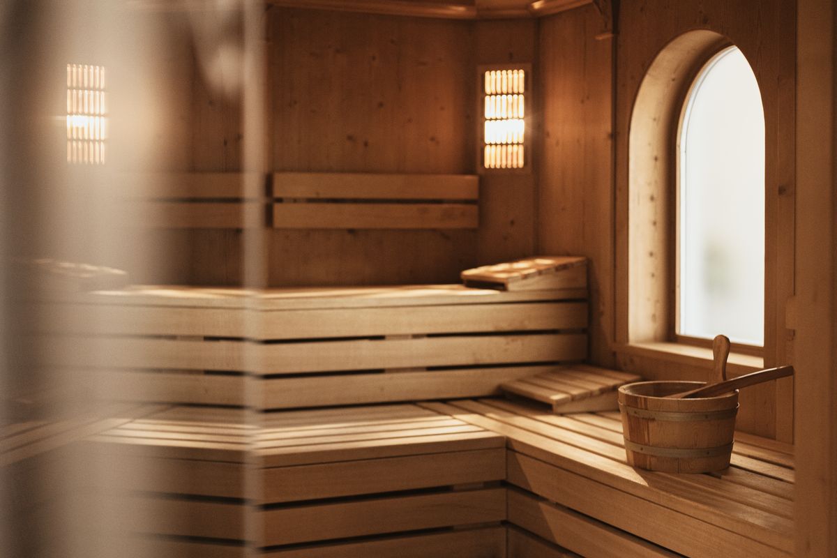 Sauna with wooden benches and bucket