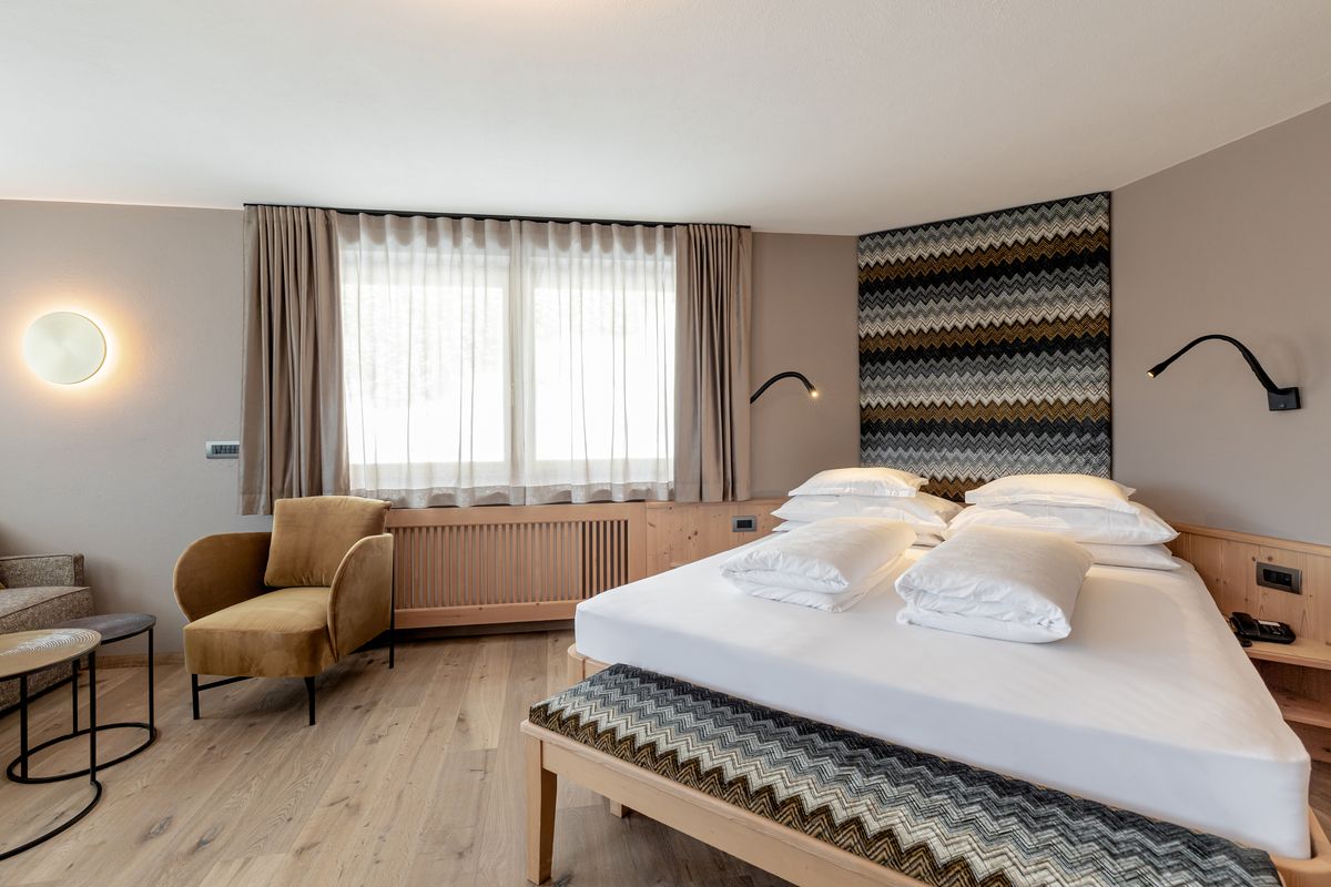 Room with double bed and armchair