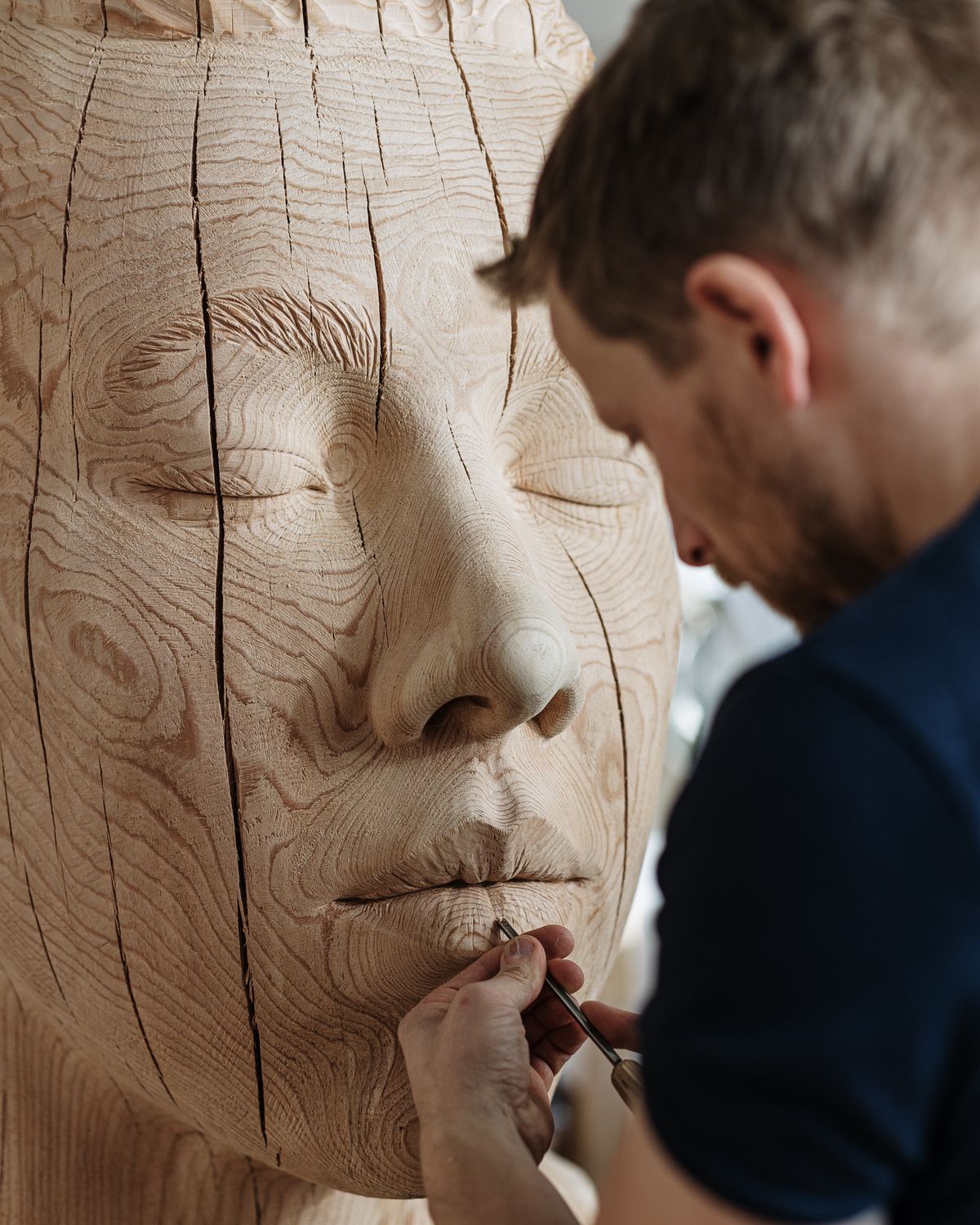 Sculptor working on a large face