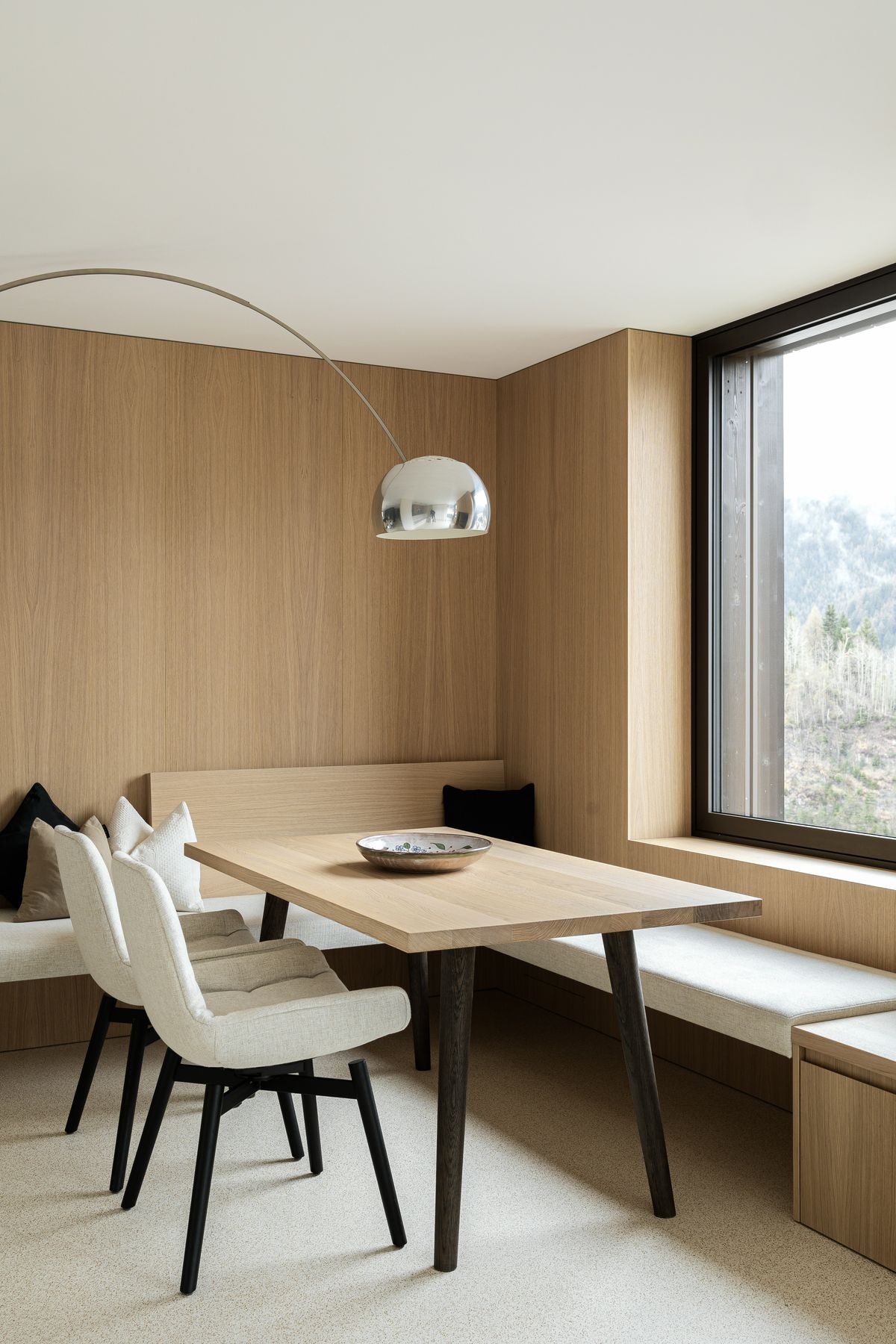 Dining nook with corner bench and arc lamp