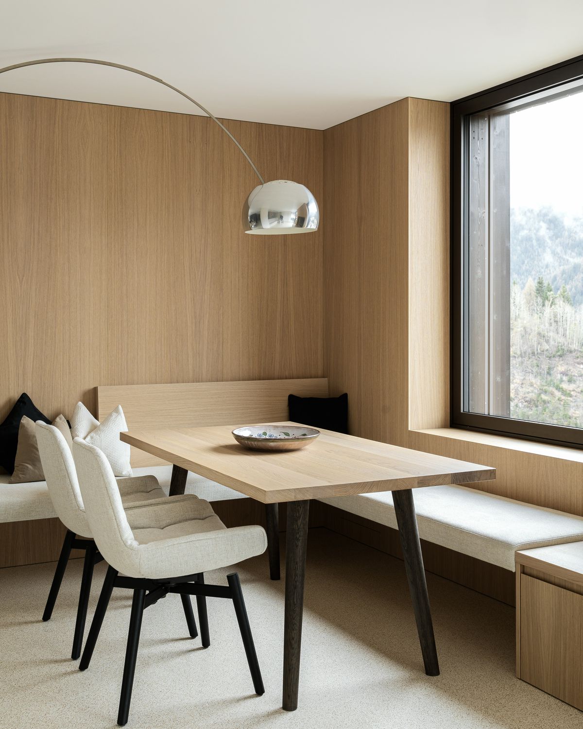 Dining nook with corner bench and arc lamp
