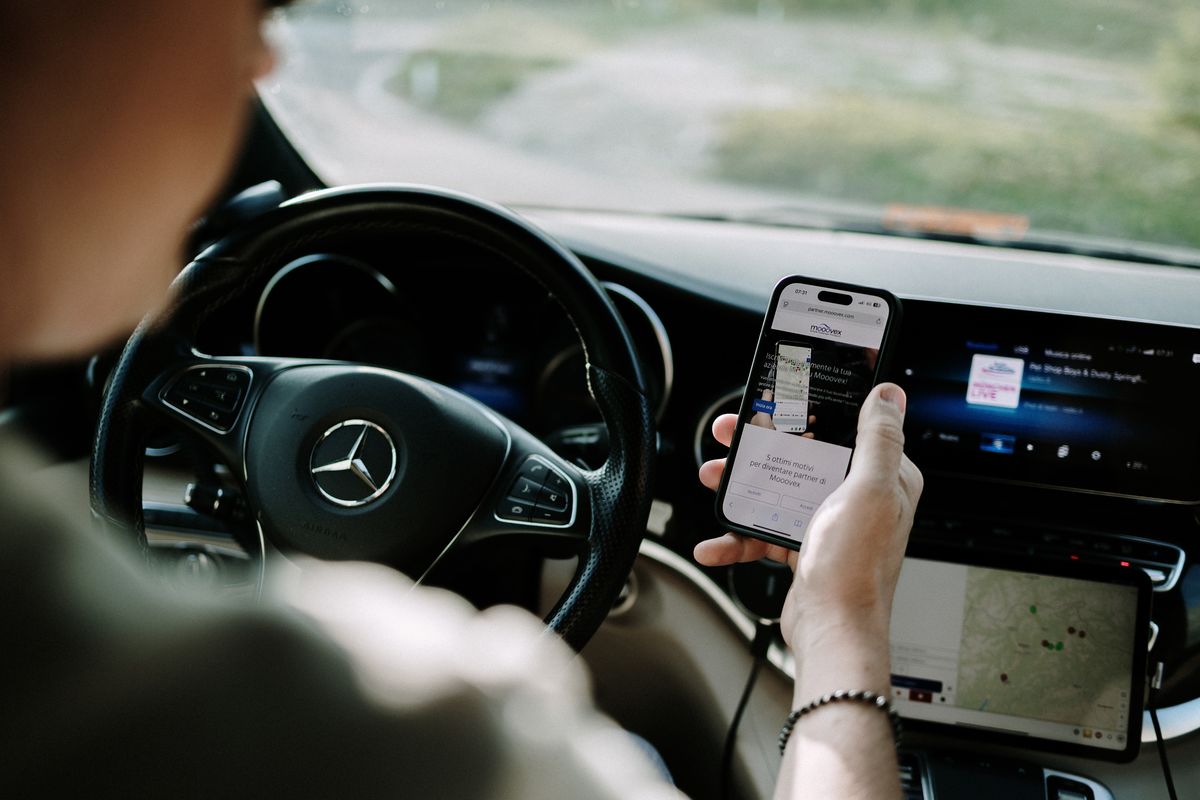 Driver with smartphone at the wheel