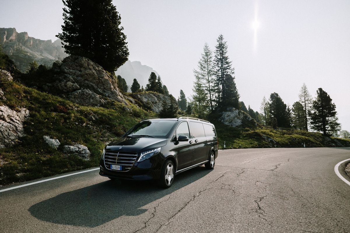 Van on the pass road in backlight