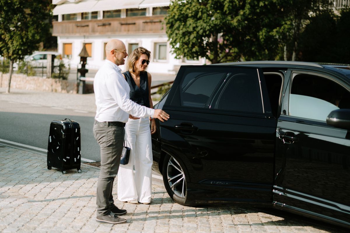 Driver opening the door for a guest
