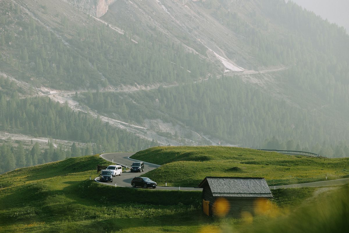 Vehicles by an alpine hut