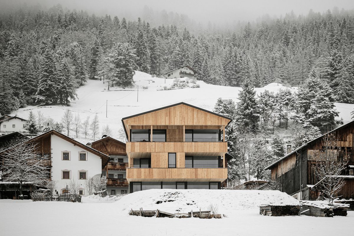 House with timber façade in the snow