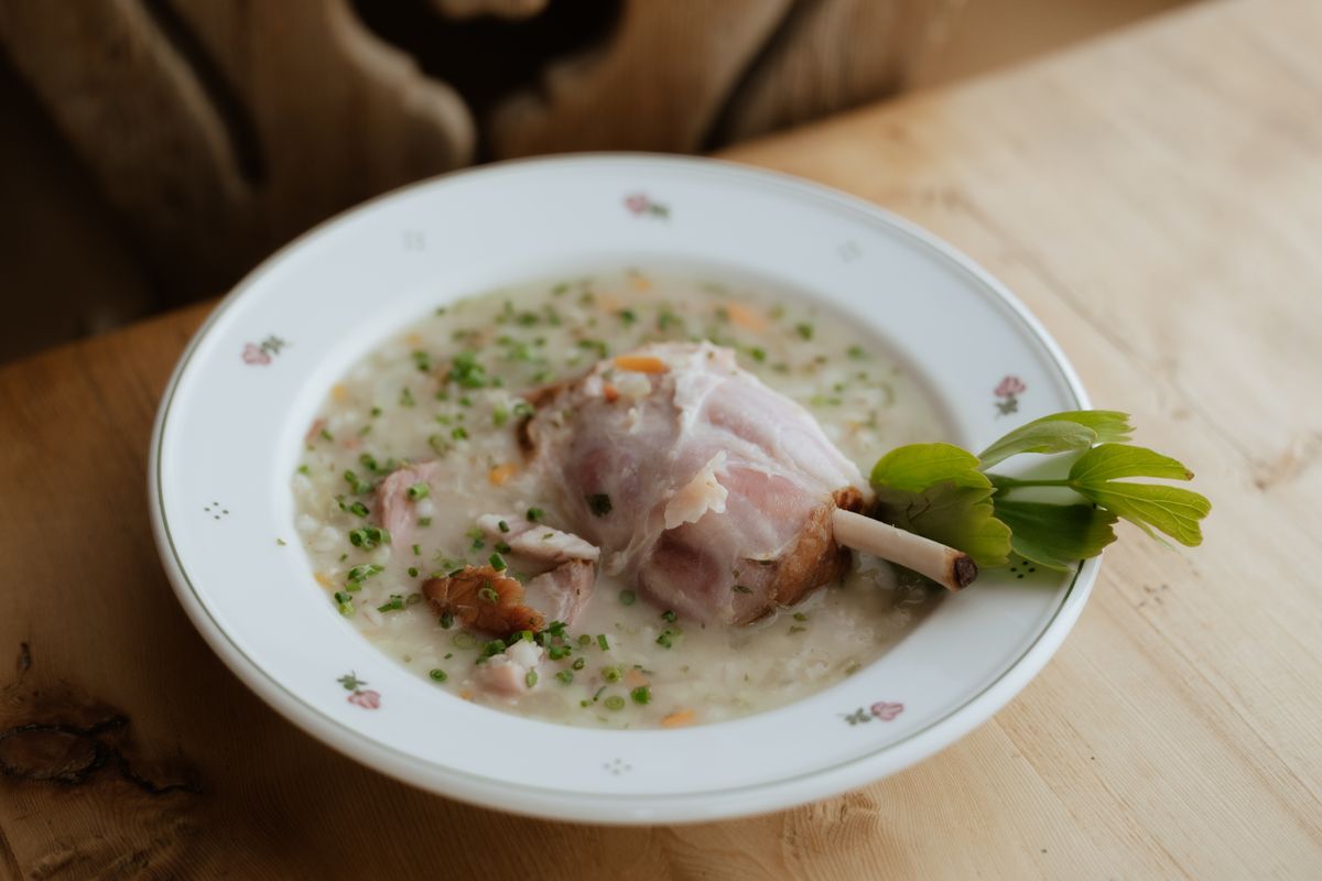 Soup with meat on the wooden table