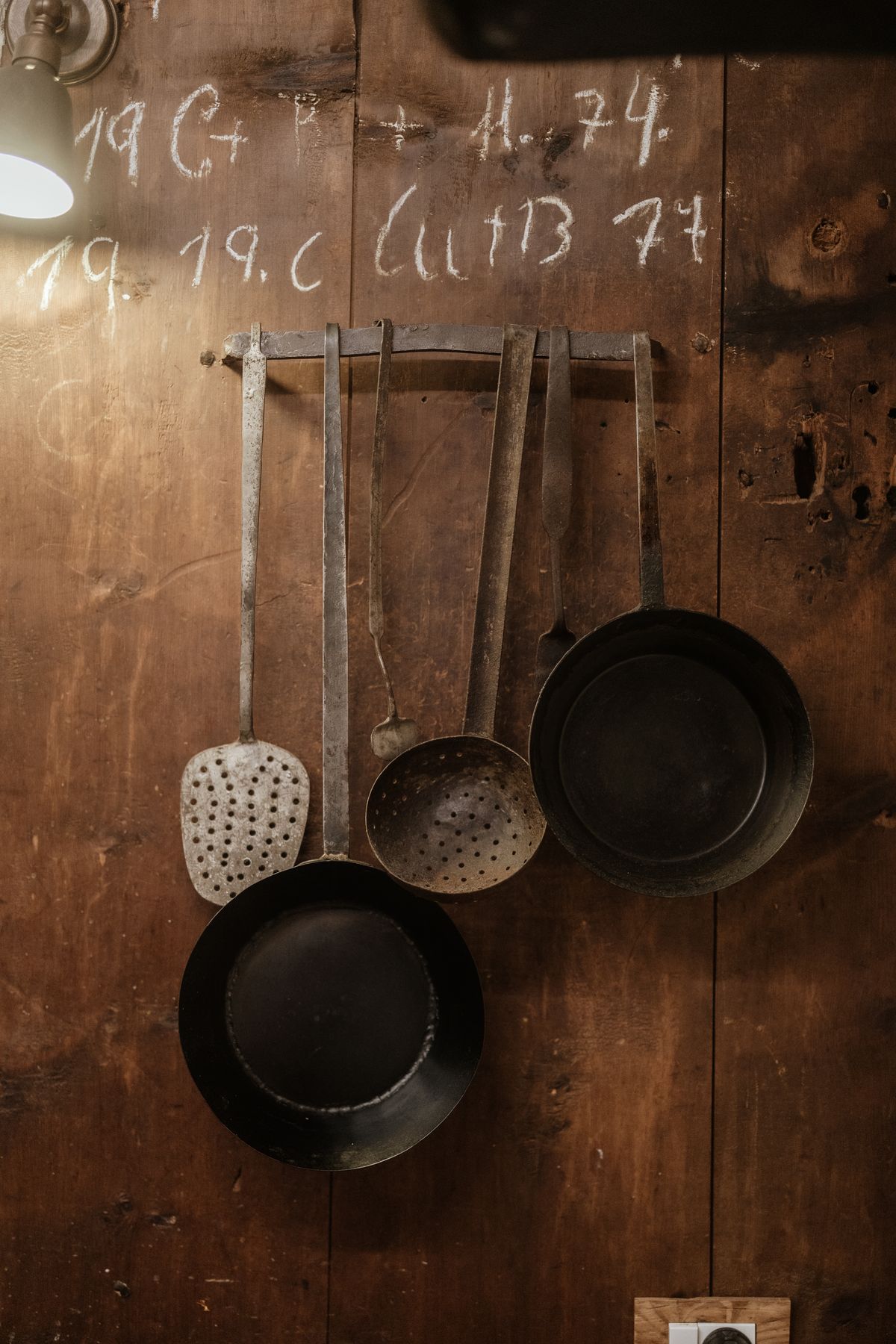 Pans hanging on the wooden wall