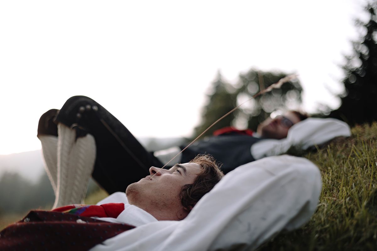 Dancers lying in the grass