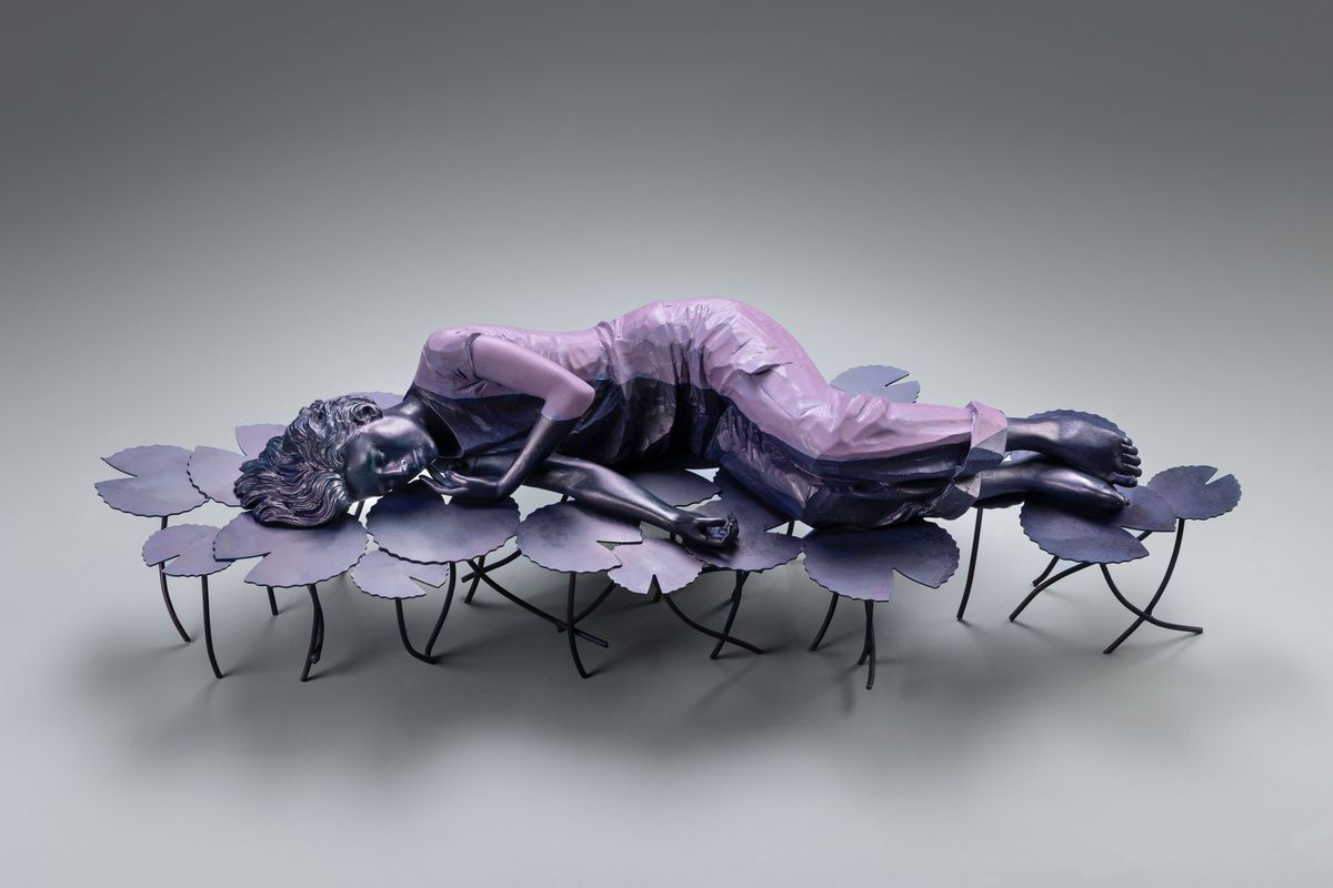 Figure lying on water-lily leaves