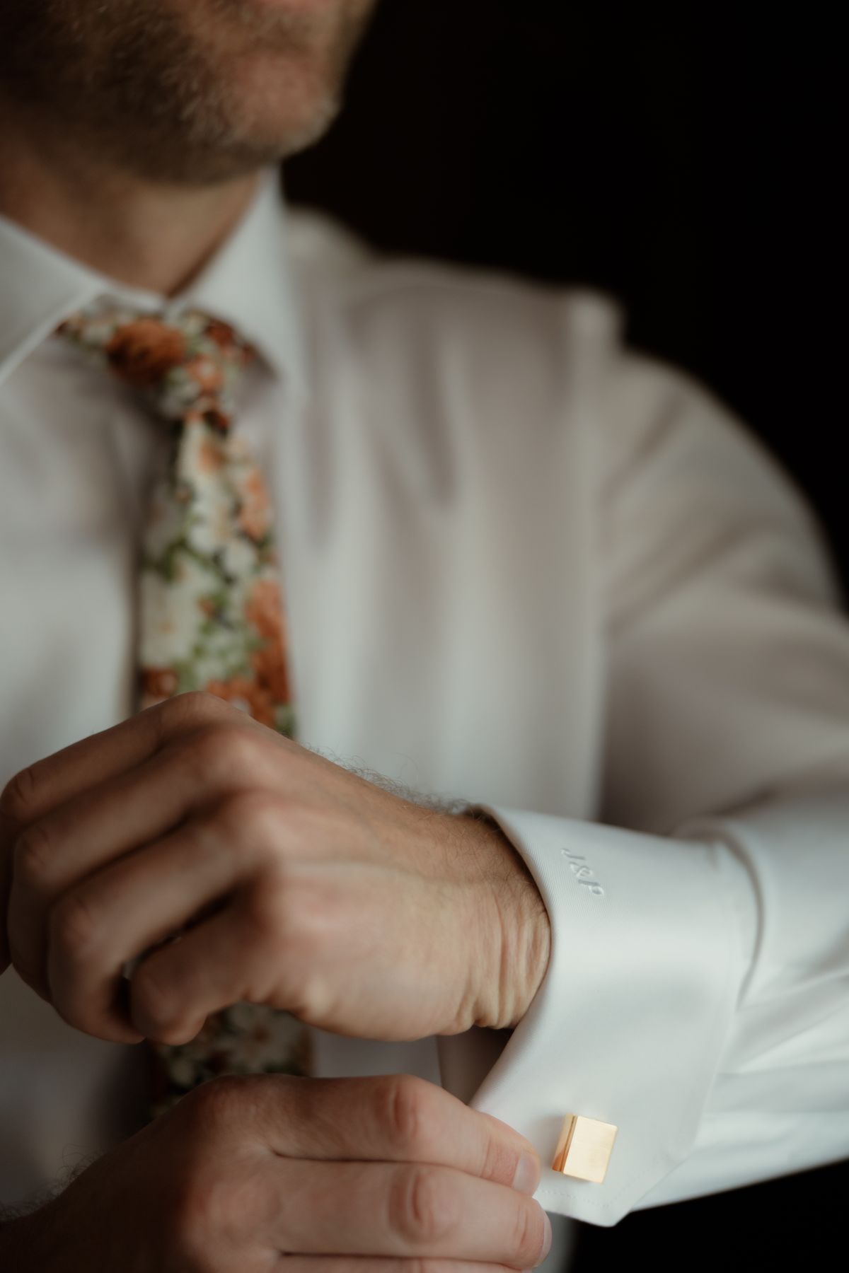 Groom fastening his cufflinks