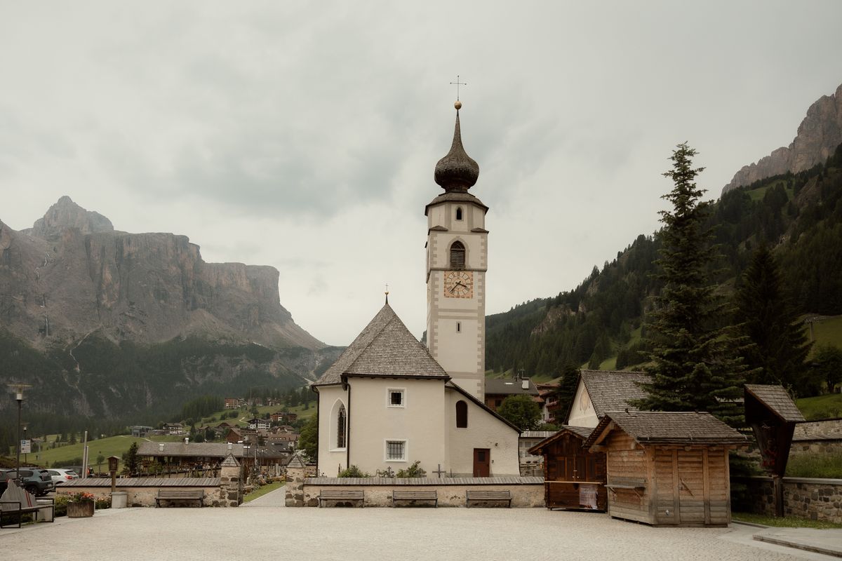 White village church below the Dolomites