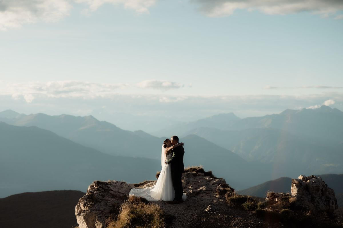 Couple on a rocky outcrop above the valley