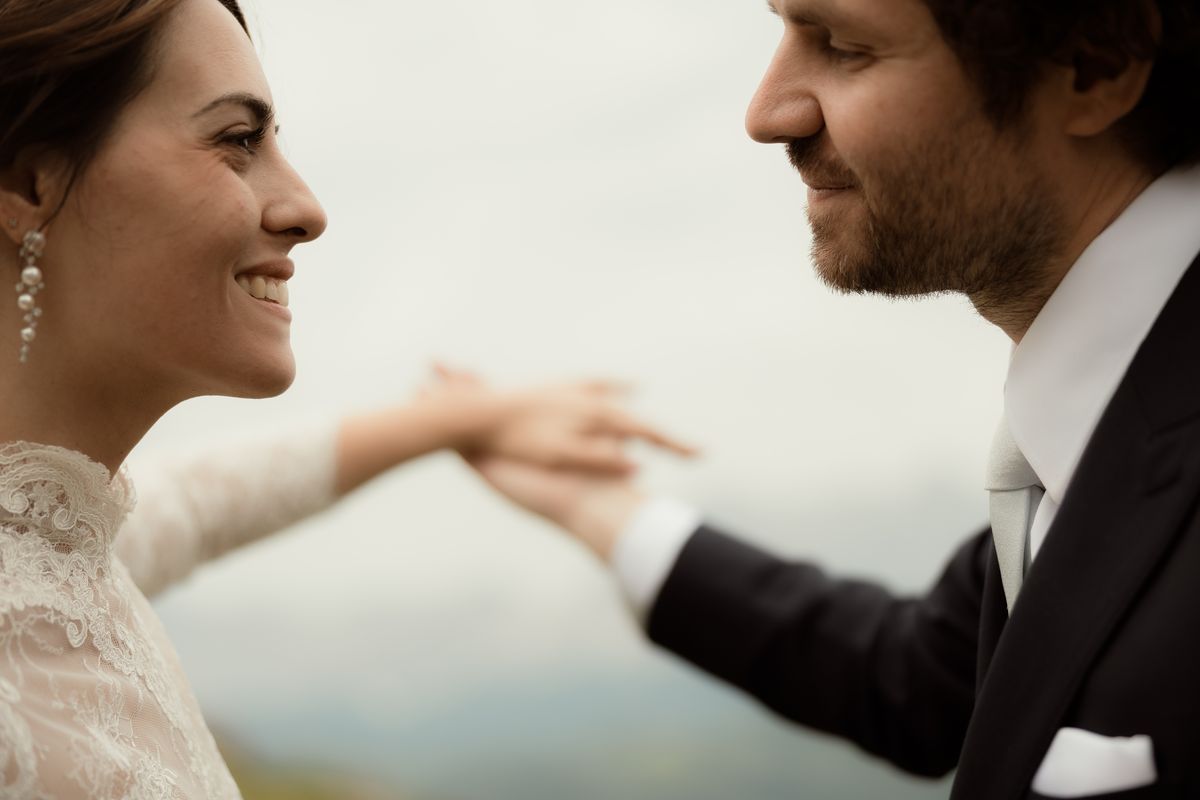 Bride and groom reaching for each other